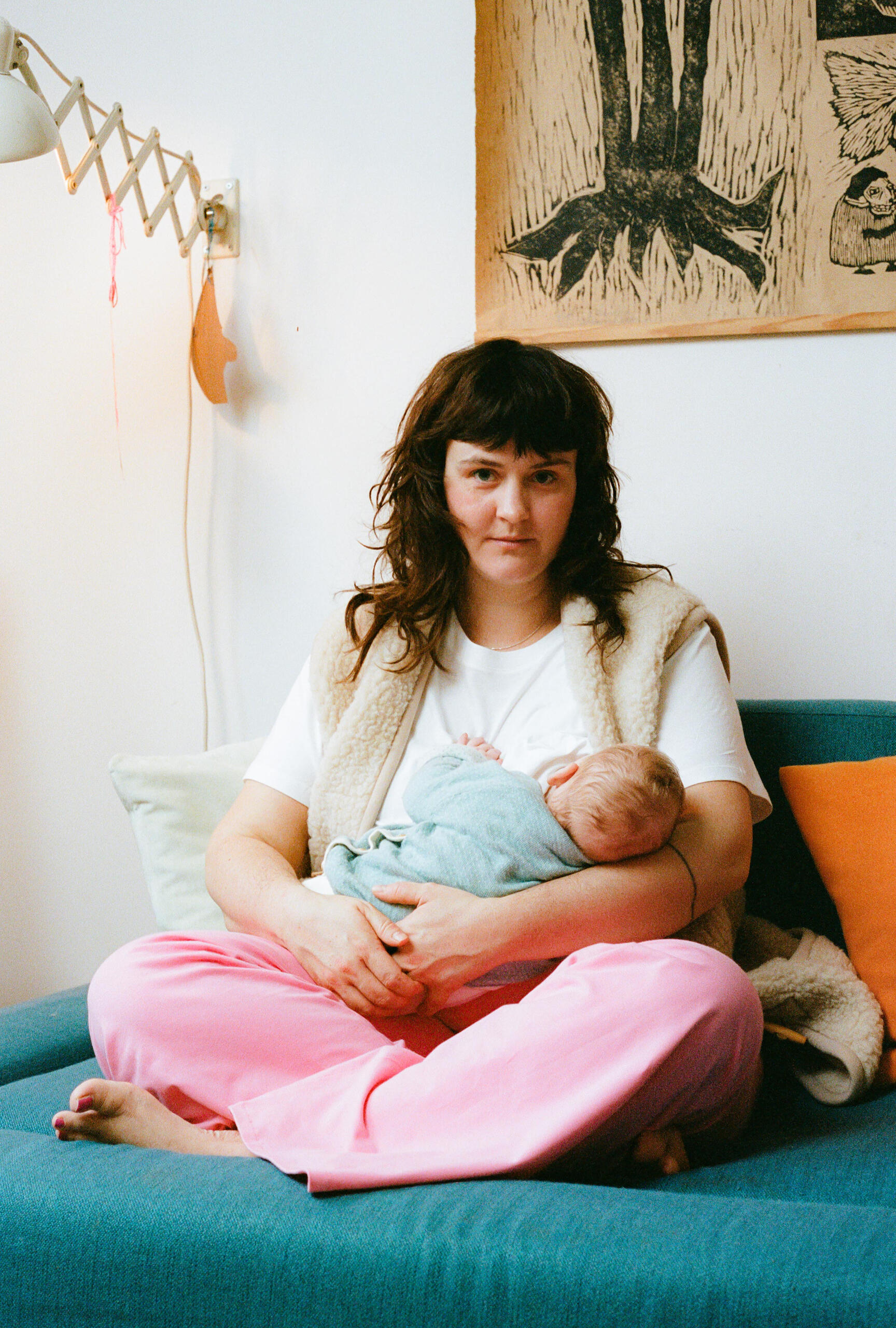 Great breastfeeding her baby Mother breastfeeding her baby, wearing sustainable maternity fashion from MIUMI and looking lovingly into the camera.